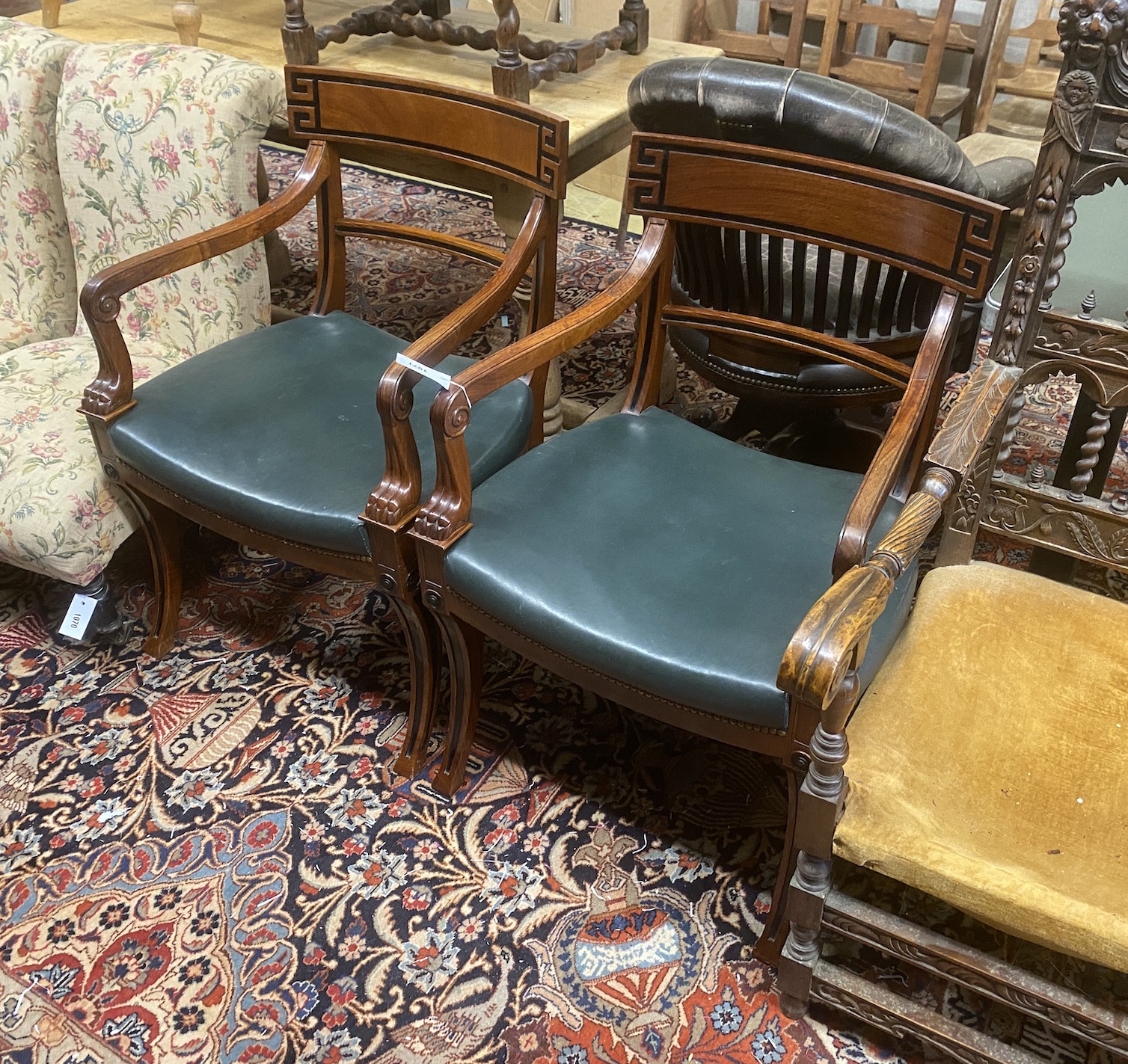 A pair of Regency style mahogany sabre leg elbow chairs, width 56cm, depth 48cm, height 87cm